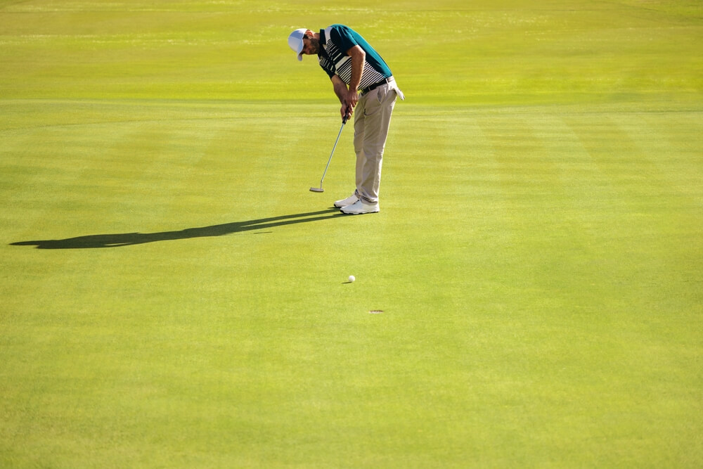 A man on one of the best Grand Cayman golf courses.
