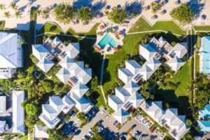 An aerial view of a Seven Mile Beach condo resort where you can research how to get around Grand Cayman.