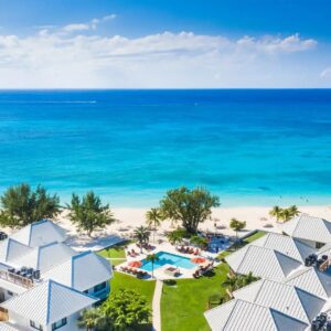 A view of a pool and condo rentals to stay at on a Grand Cayman fall vacation.